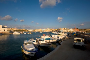 The wooden fishing boats anchored in front of the surgery clinic for marine turtles of Lampedusa © Philippe Henry / OCEAN71 Magazine