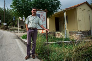 Spiros Couvaras in front of a small exhibition in Stavros village on the hints that lead a lot of people to believe that modern and ancient Ithaca are the same © Philippe Henry / OCEAN71 Magazine